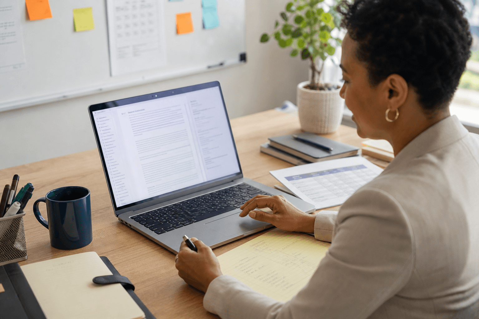 Nonprofit grant writer reviewing AI-generated grant proposal content