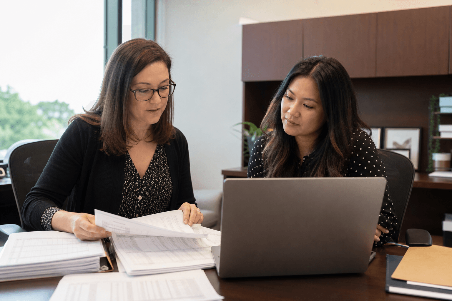 Research administration staff reviewing grant expenditure records
