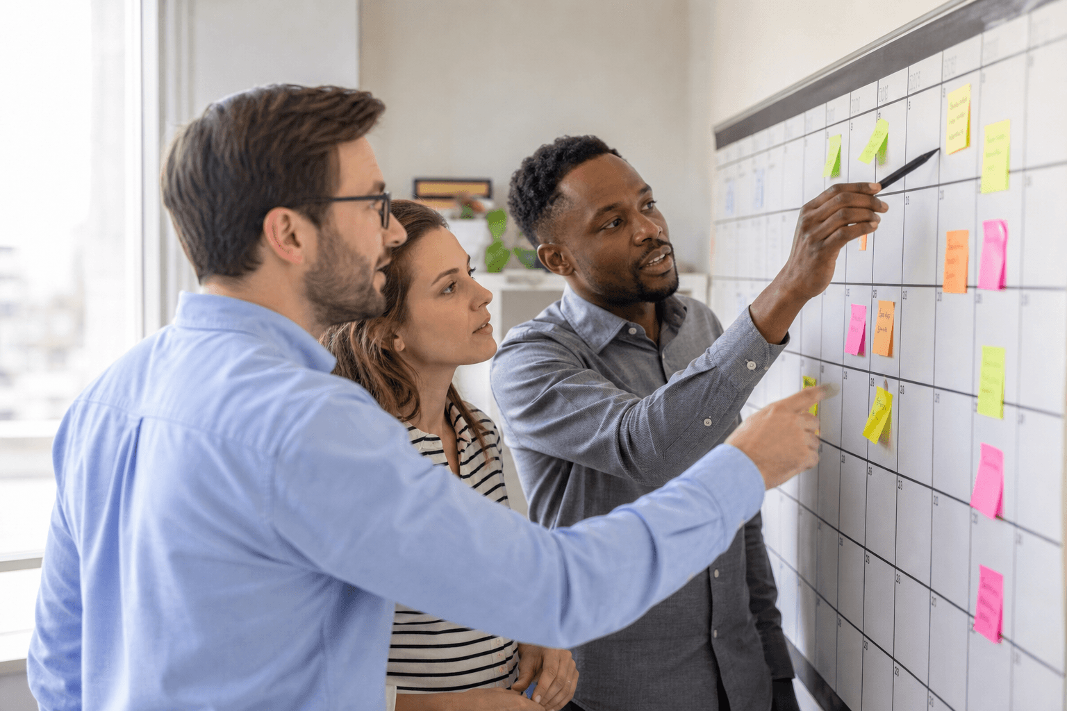 Grants team planning September deadlines at a shared calendar wall