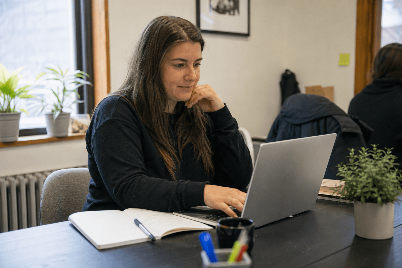 Nonprofit staff member reviewing federal funding opportunity listings on a laptop