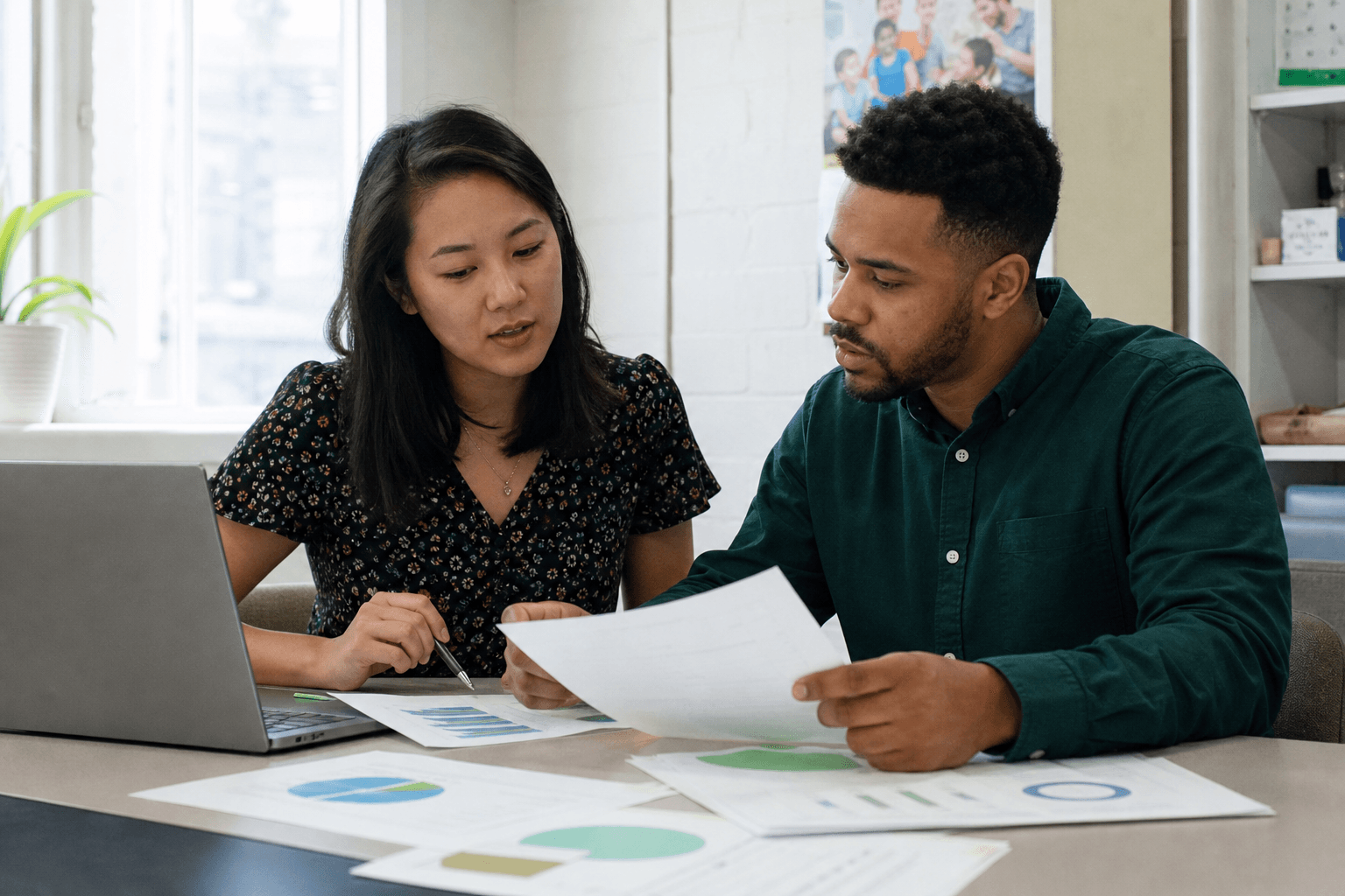 Nonprofit staff reviewing participant survey results during a program evaluation