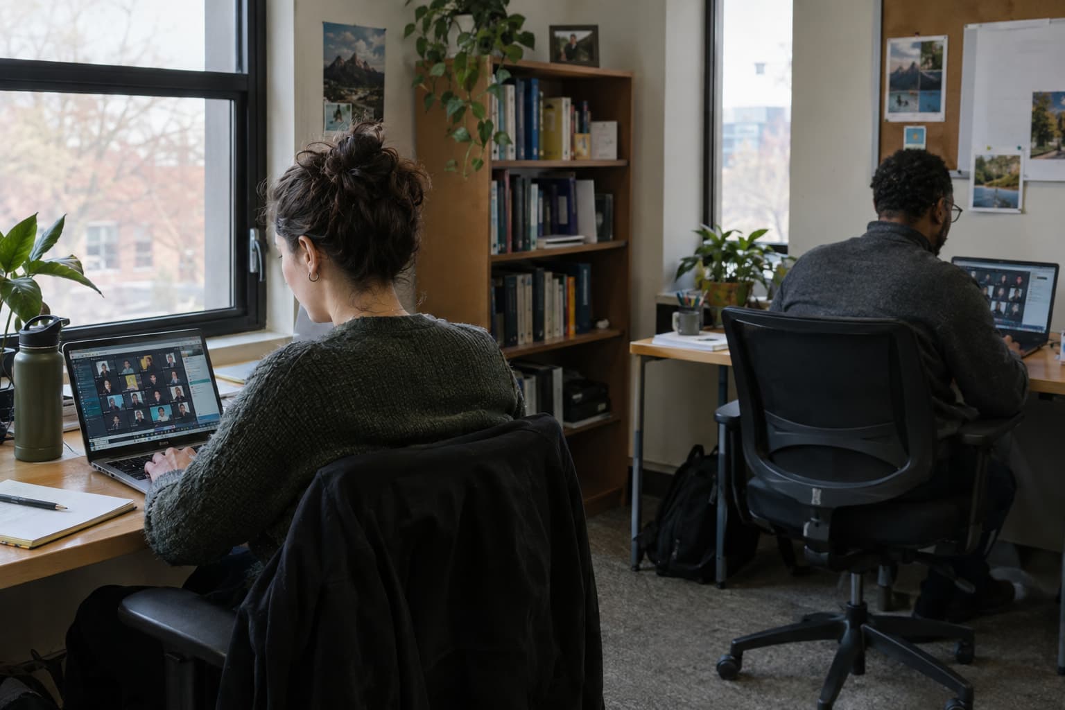 Two nonprofit colleagues working on the same shared sheet from separate desks