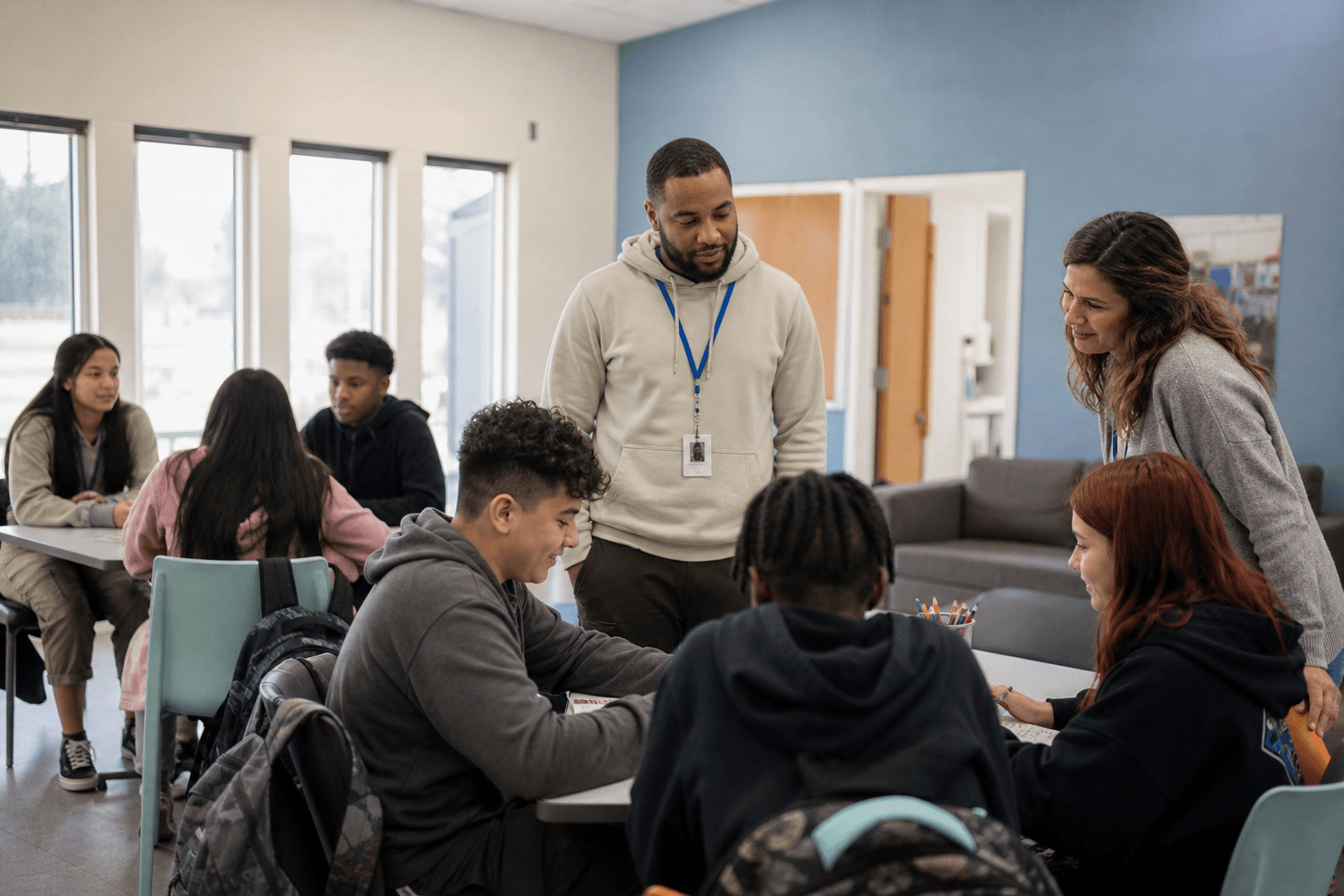 After-school staff supervising middle school students in a community program room