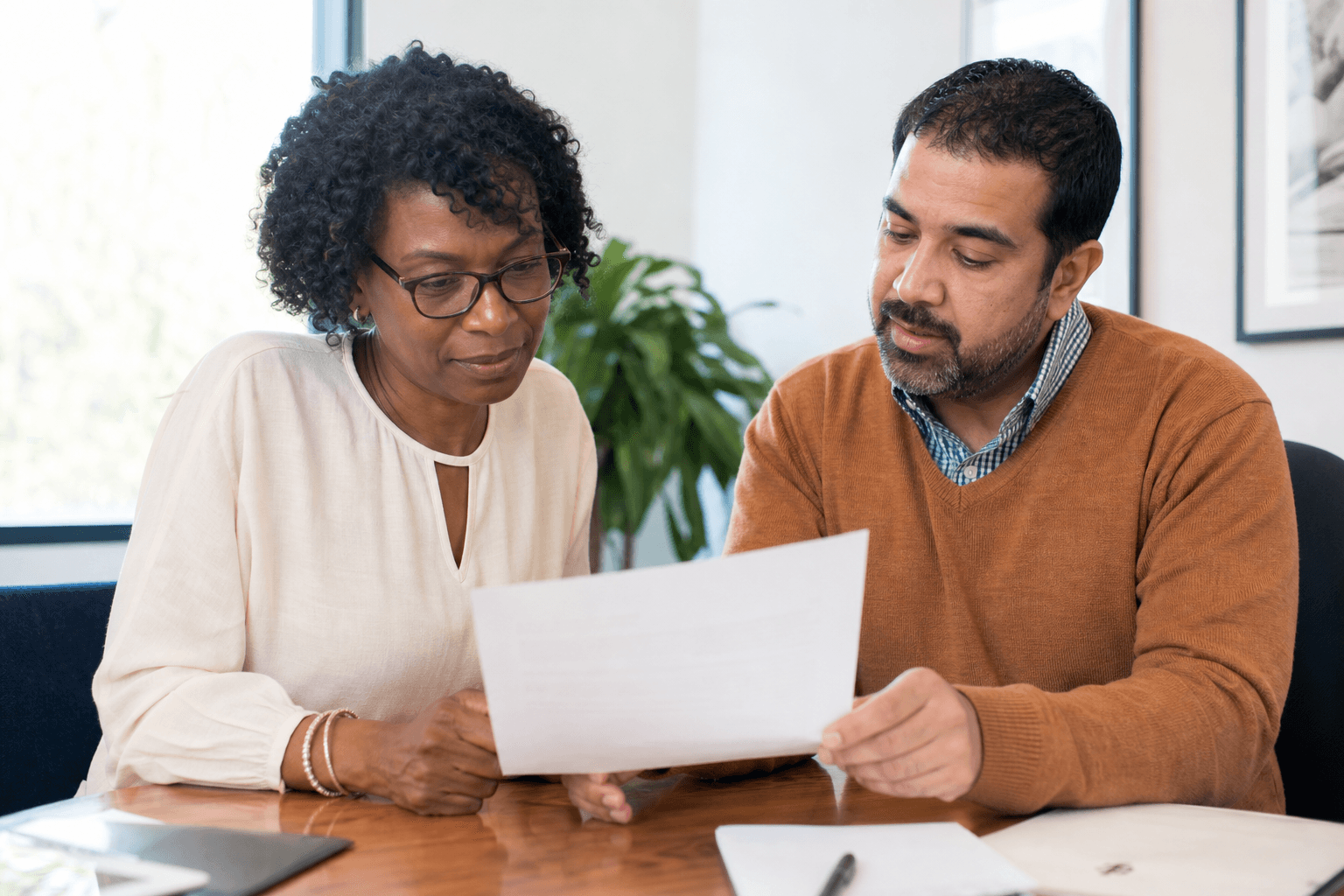 Two nonprofit partners reviewing a support letter before a grant deadline