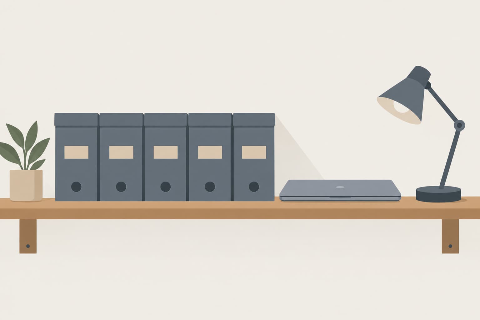 A row of archive boxes on a shelf beside a closed laptop